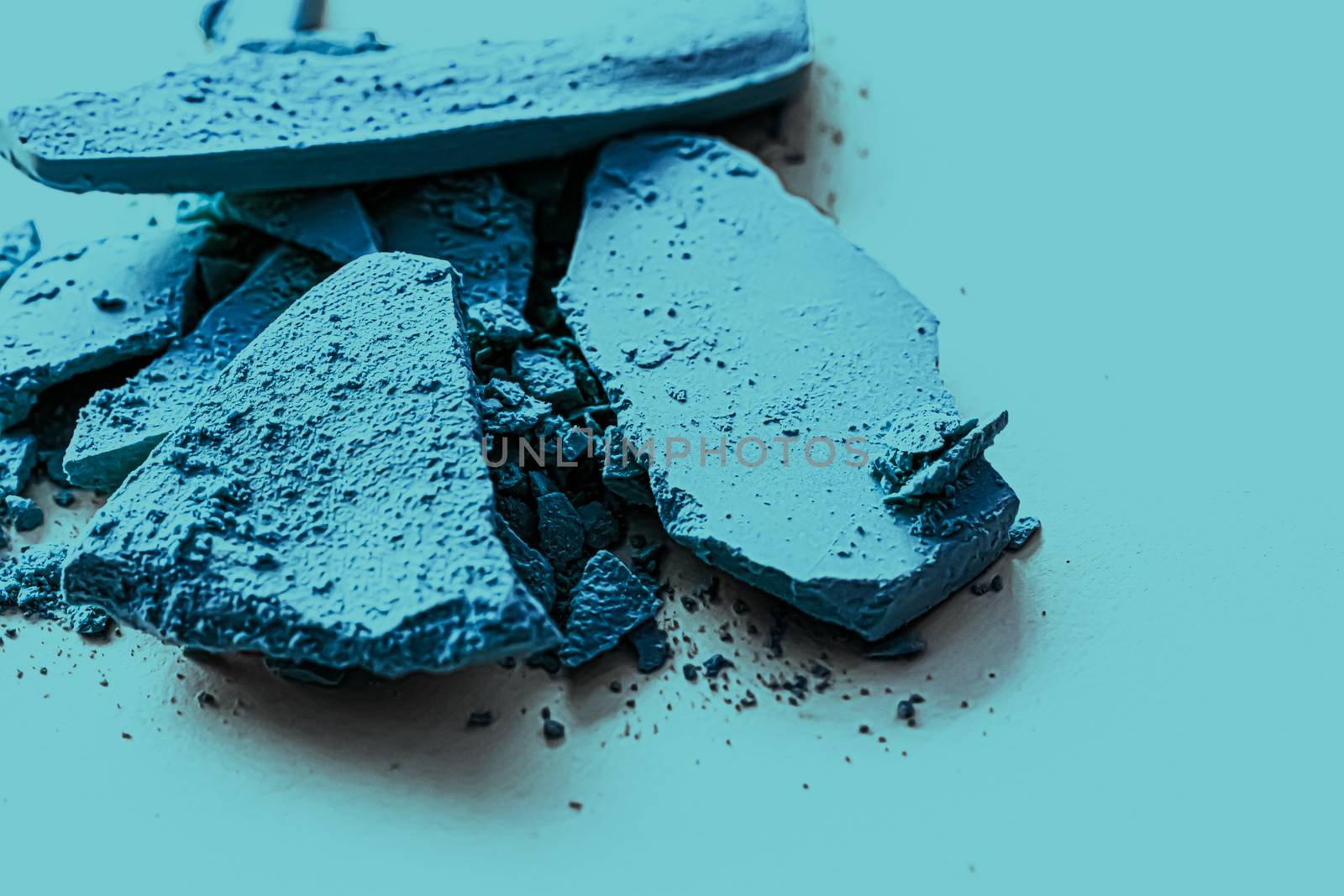 Blue eye shadow powder as makeup palette closeup, crushed cosmet by Anneleven