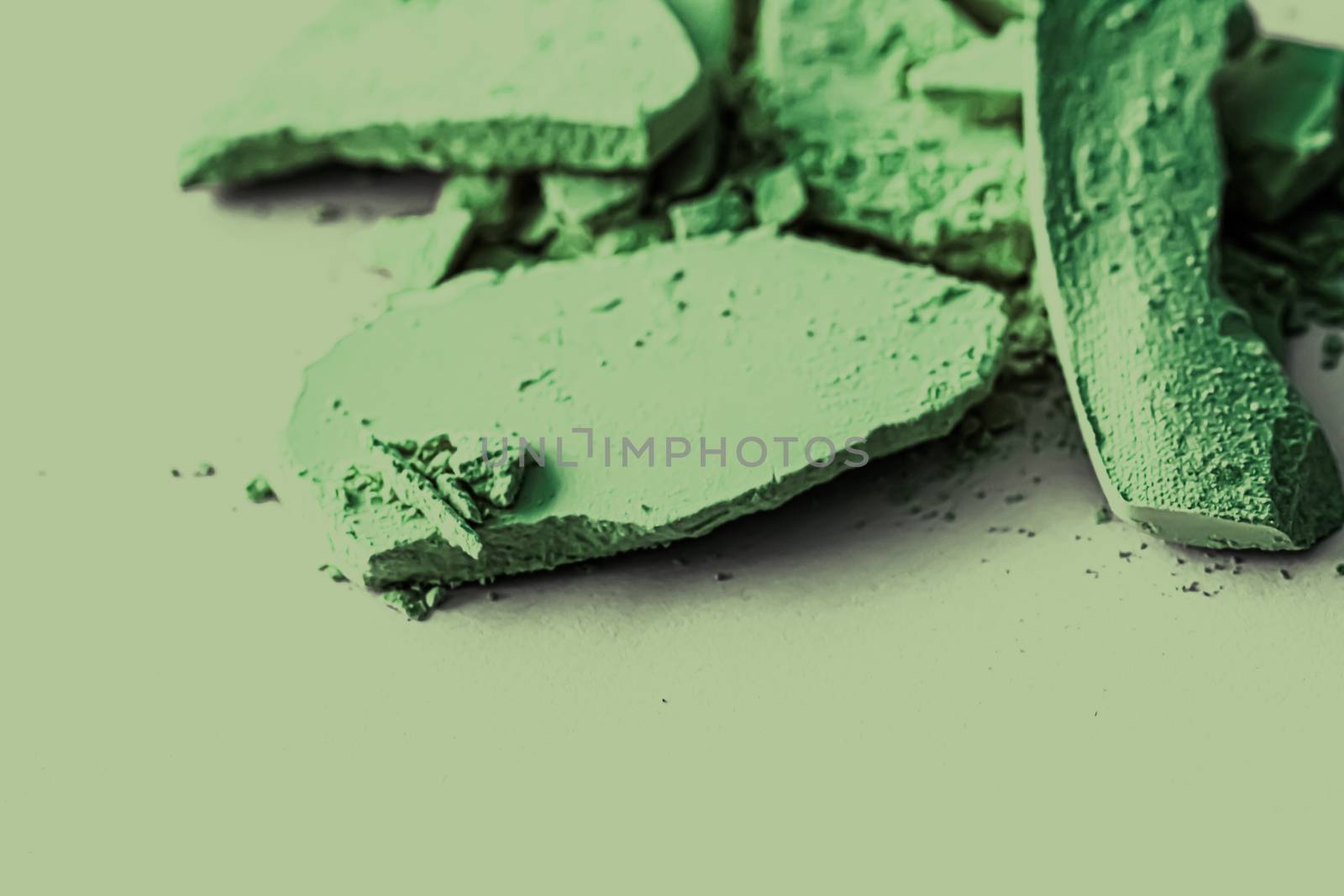 Green eye shadow powder as makeup palette closeup, crushed cosme by Anneleven