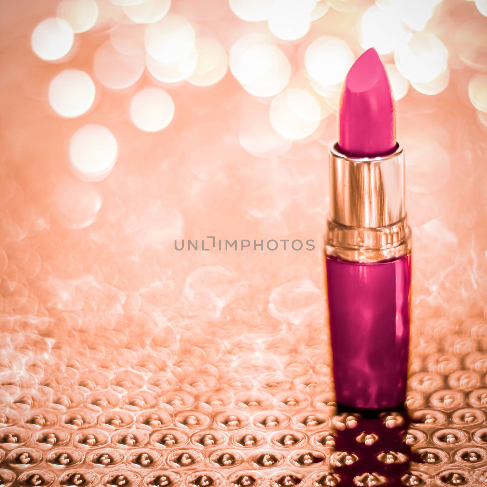 Cosmetic branding, sale and glamour concept - Pink lipstick on rose gold Christmas, New Years and Valentines Day holiday glitter background, make-up and cosmetics product for luxury beauty brand
