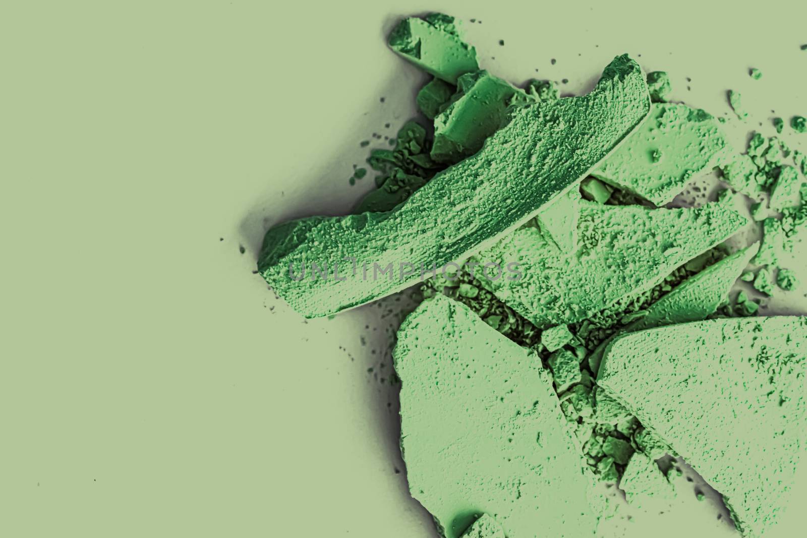 Green eye shadow powder as makeup palette closeup, crushed cosmetics and beauty textures