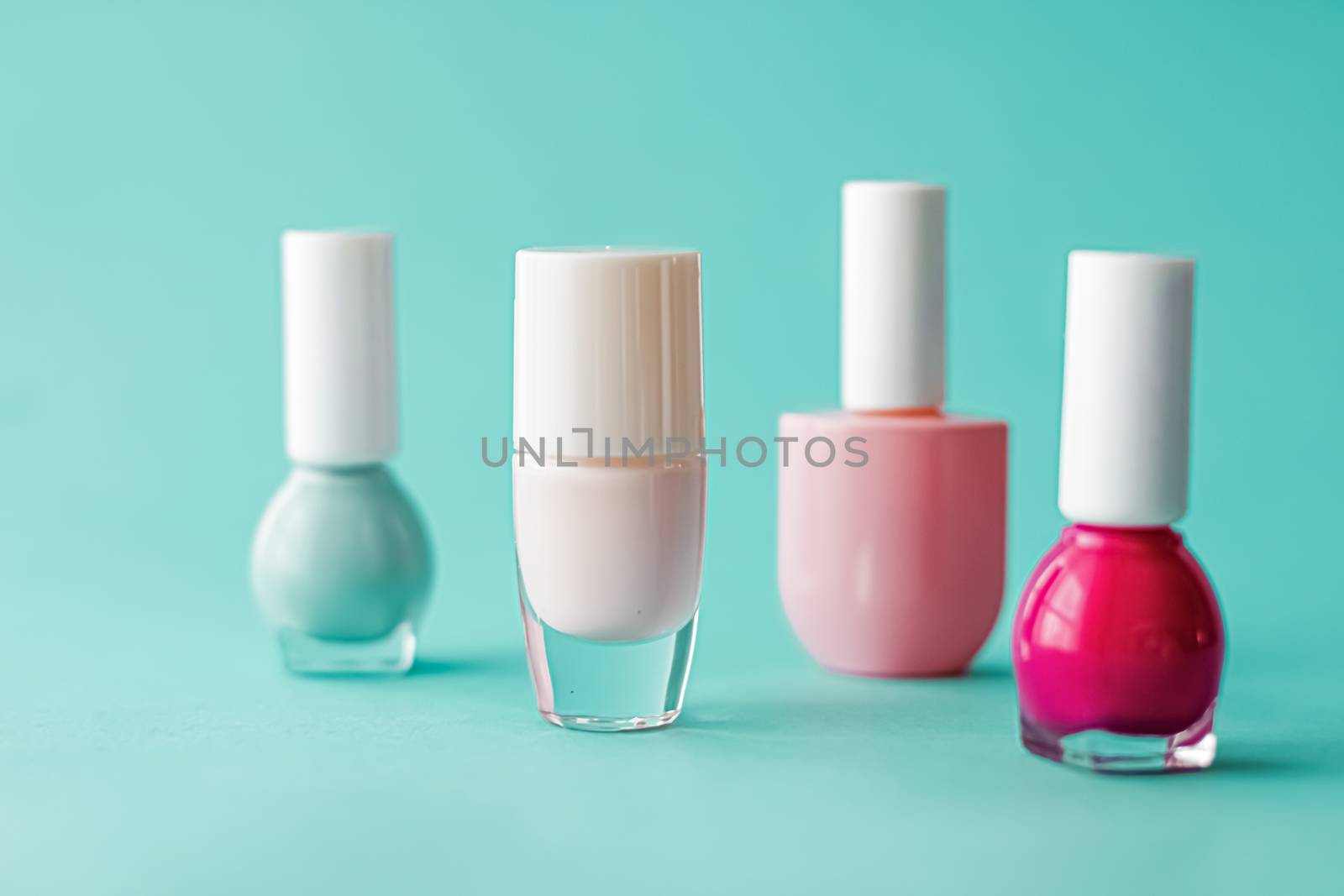 Nail polish bottles on green background, beauty brand by Anneleven