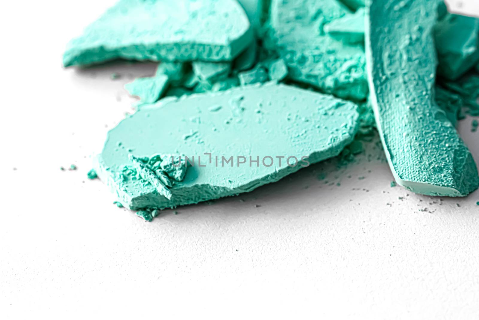 Mint eye shadow powder as makeup palette closeup isolated on white background, crushed cosmetics and beauty textures