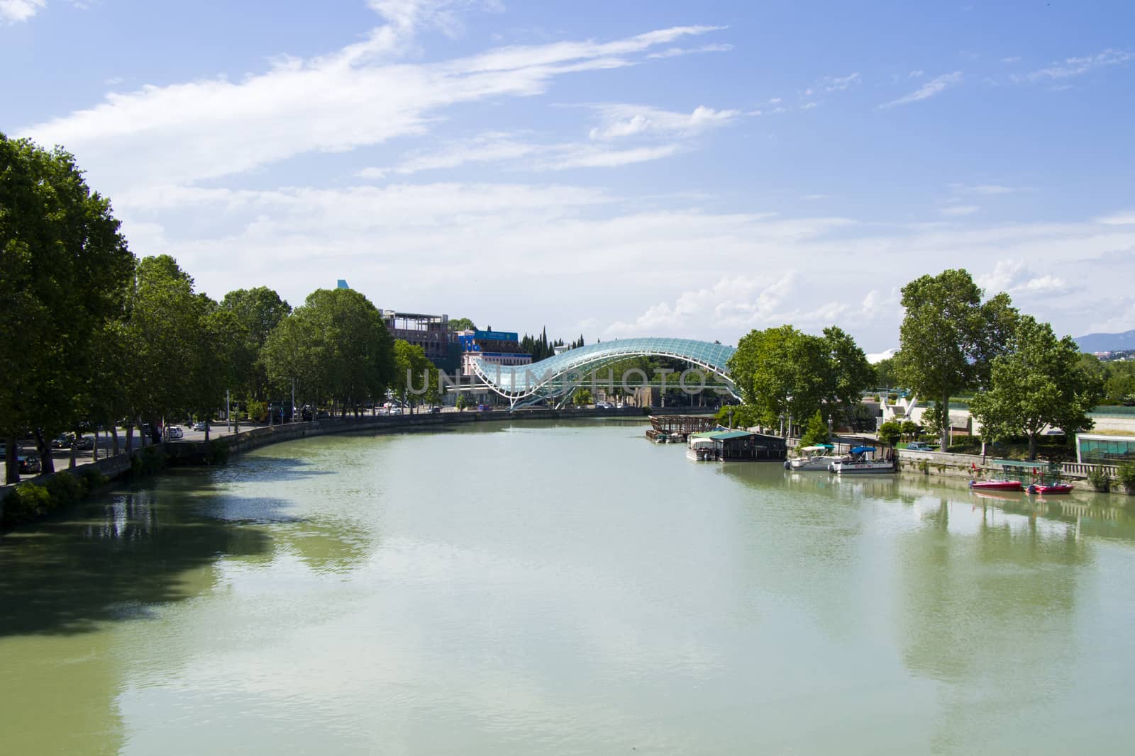 Glass bridge and Mtkvari river in old town and city center of Tbilisi, Georgia by Taidundua