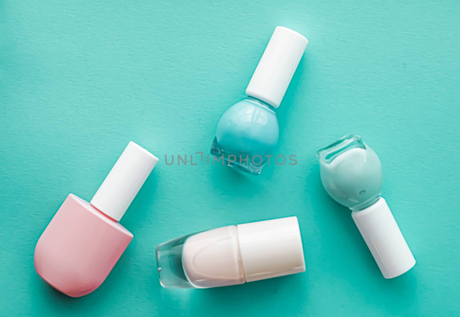 Nail polish bottles on green background, beauty brand by Anneleven