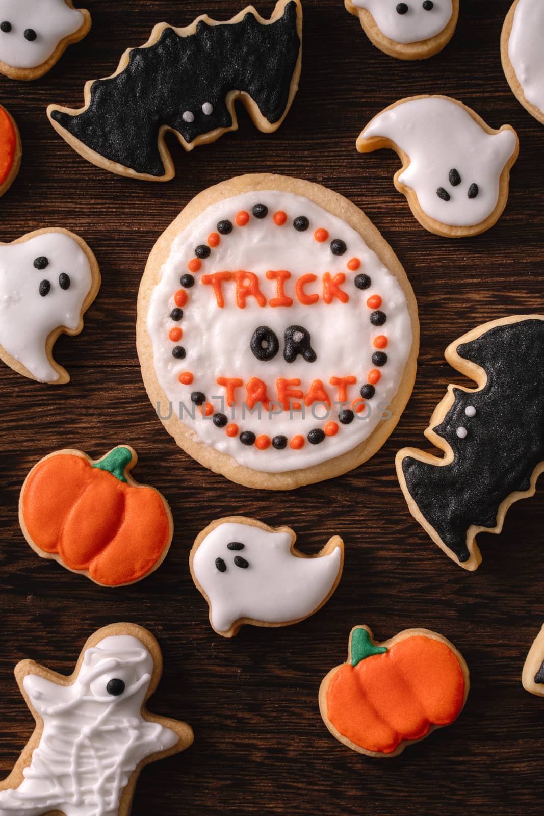 Top view of Halloween festive decorated icing gingerbread sugar cookies with copy space and flat lay layout.