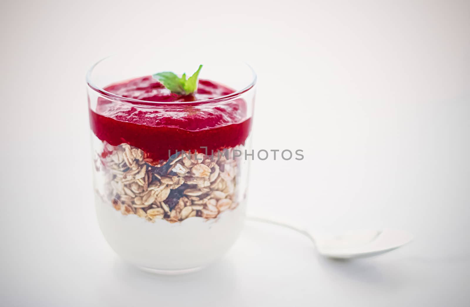 Sweet, oat and vegan concept - Homemade granola parfait with berry jam and mint, yogurt and muesli cereal as healthy breakfast food in the morning, organic dairy yoghurt for diet nutrition brand