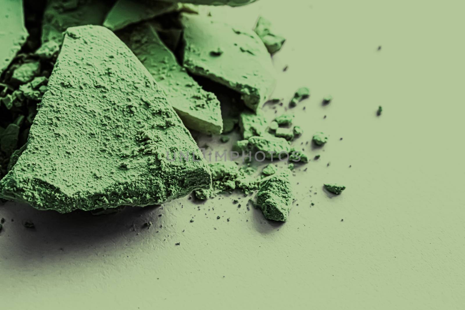 Green eye shadow powder as makeup palette closeup, crushed cosme by Anneleven