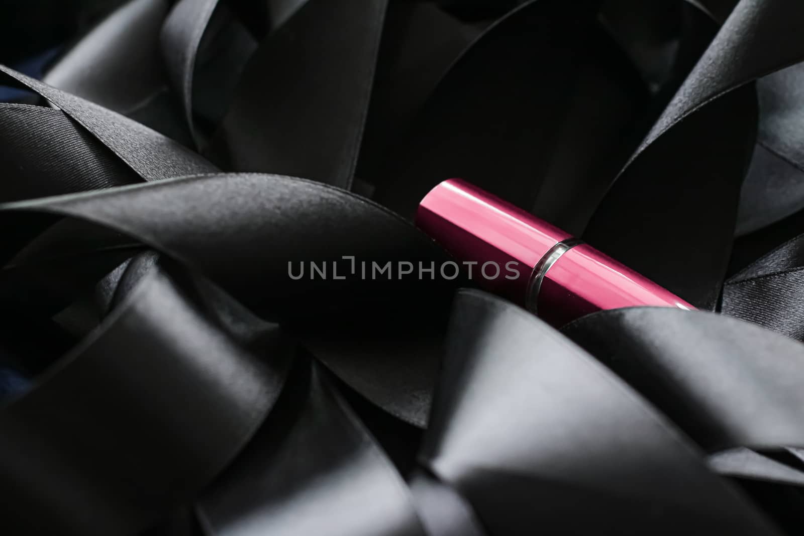 Pink lipstick on black silk background, luxury make-up and beaut by Anneleven