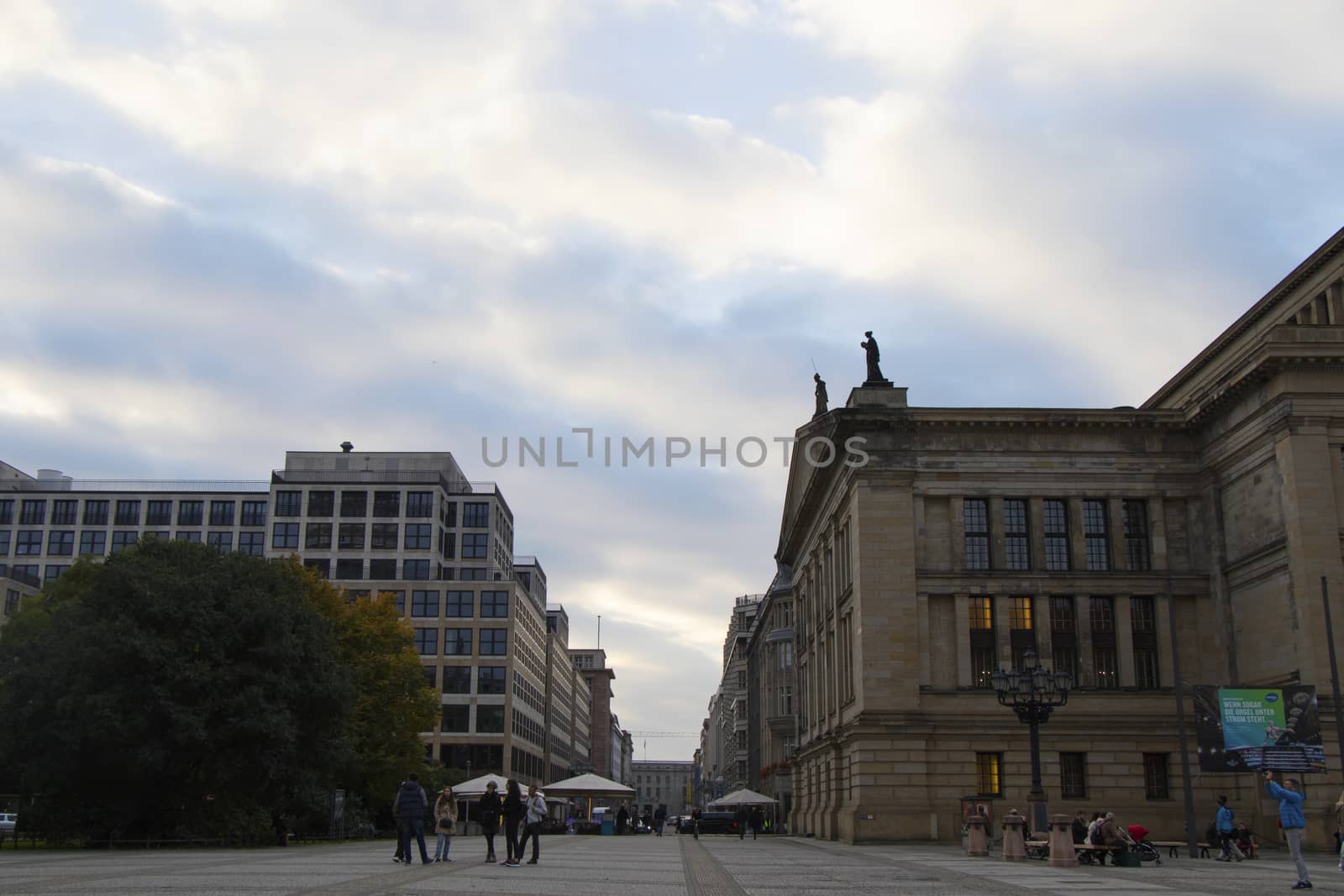 BERLIN, GERMANY - OCTOBER 13, 2017: Buildings located on Gendarmenmarkt square near the historic center of the city. People and street.