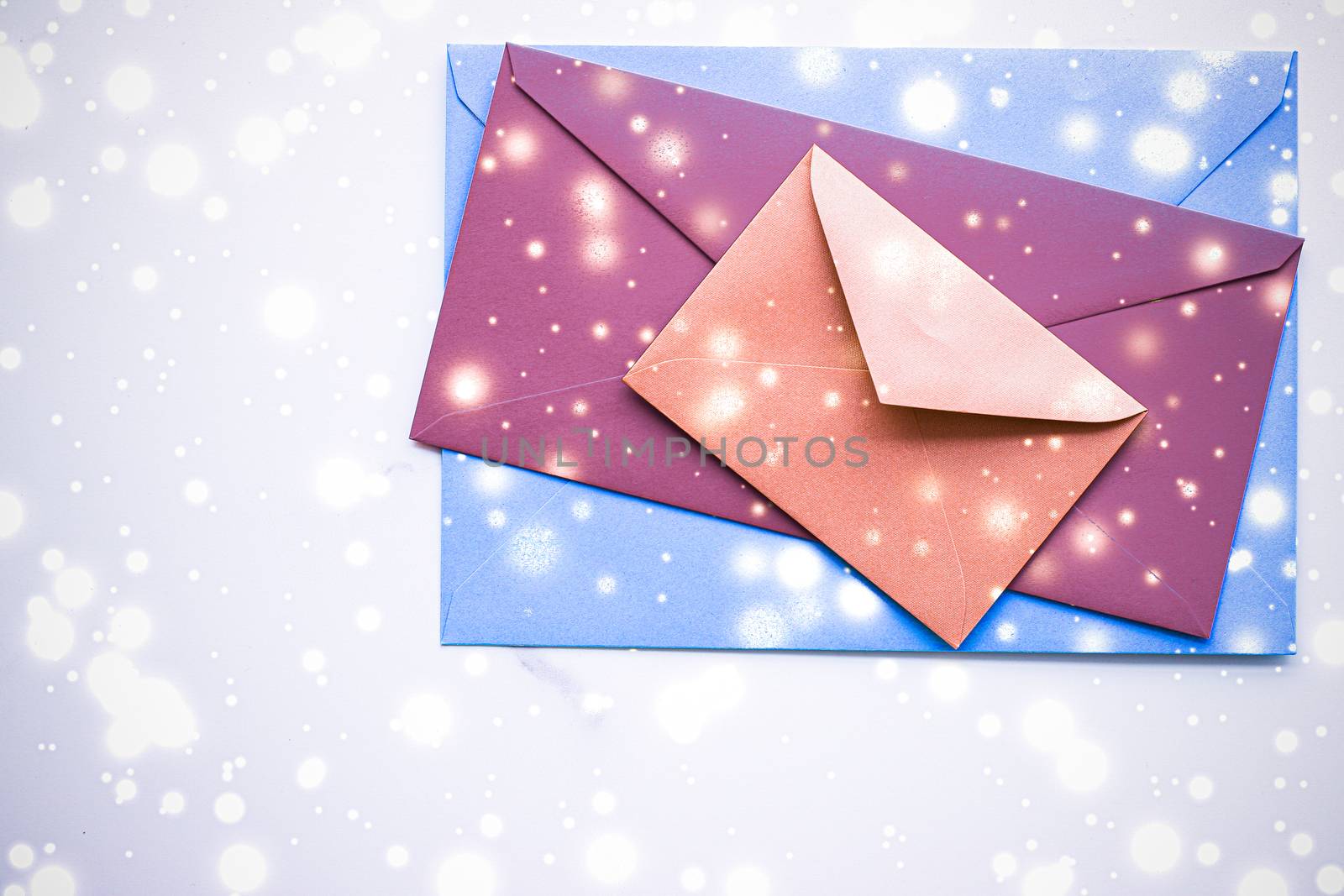 Greetings, postal service and online newsletter concept - Winter holiday blank paper envelopes on marble with shiny snow flatlay background, love letter or Christmas mail card design