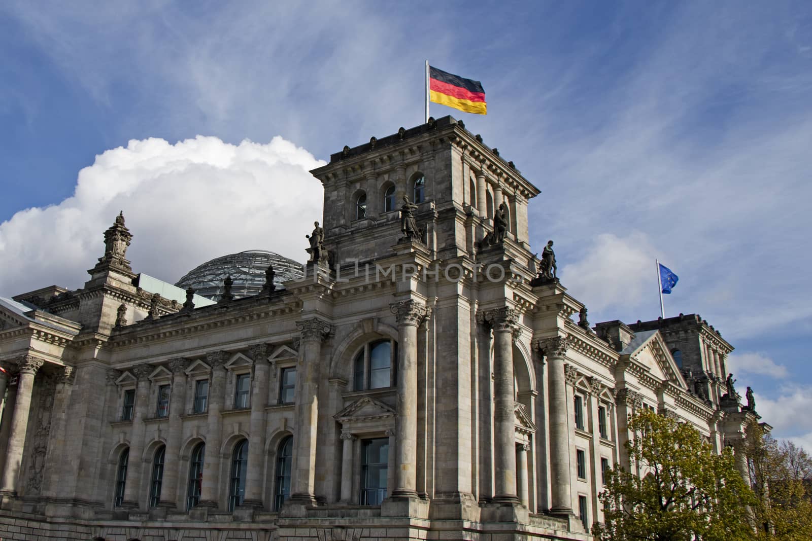 The Reichstag bears silent witness to the turbulent history of Berlin and is one of the city’s most significant historical buildings. Reichstag's Famous landmark and architecture and Germany flag in the center Berlin, Germany