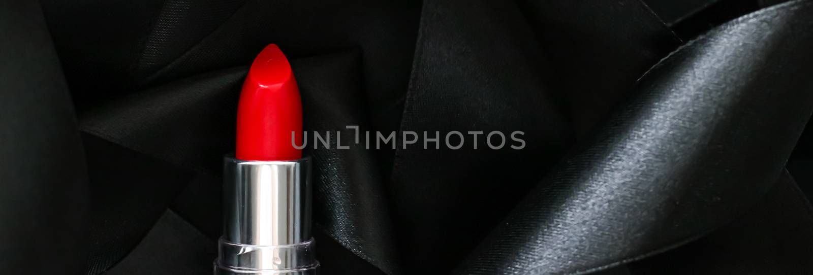 Red lipstick on black silk background, luxury make-up and beauty by Anneleven