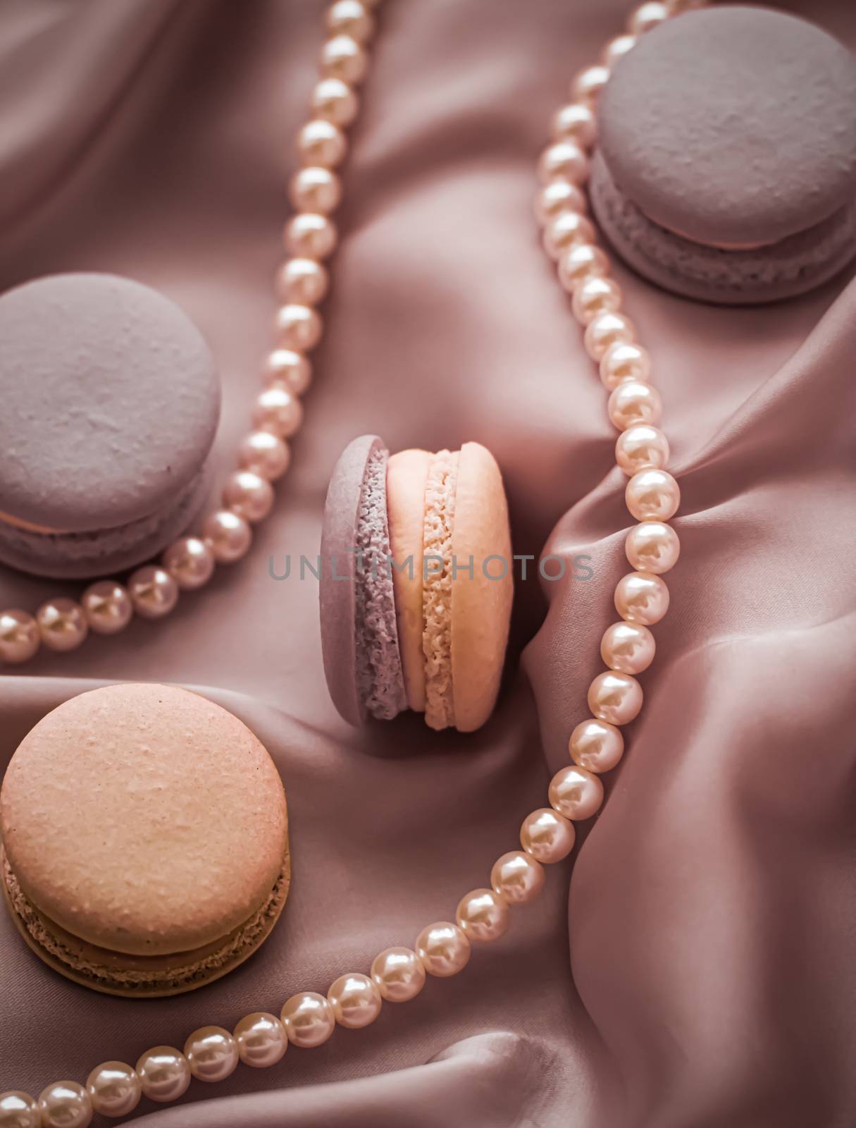 Sweet macaroons and pearls jewellery on silk background, parisia by Anneleven