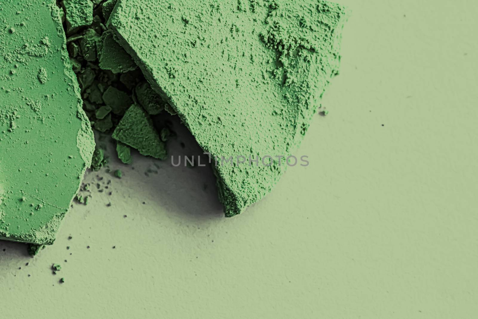 Green eye shadow powder as makeup palette closeup, crushed cosme by Anneleven