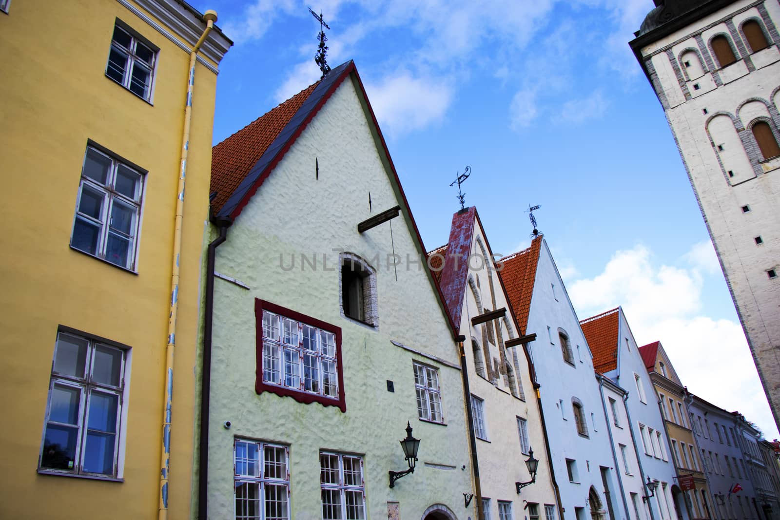 Buildings and architecture exterior view in old town of Tallinn, colorful old style houses and street situation. by Taidundua