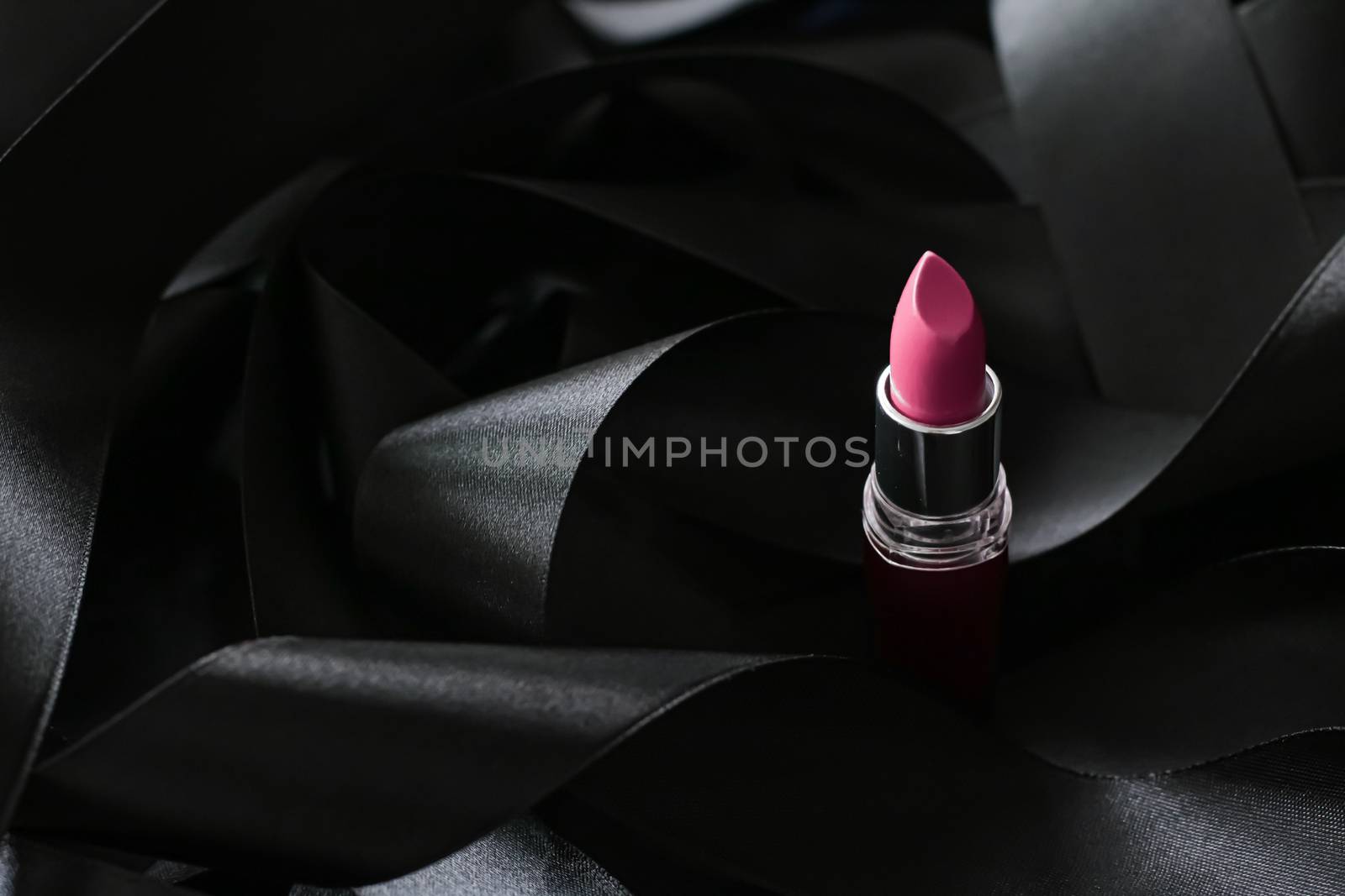 Pink lipstick on black silk background, luxury make-up and beaut by Anneleven