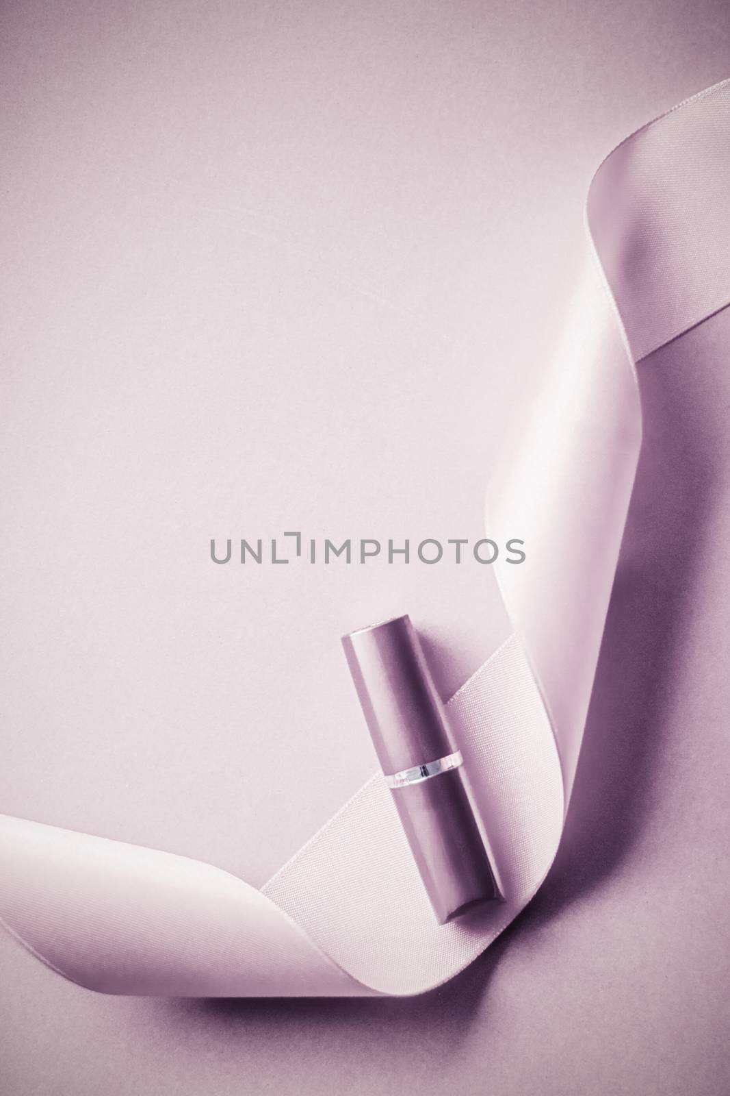 Cosmetic branding, glamour lip gloss and shopping sale concept - Luxury lipstick and silk ribbon on blush purple holiday background, make-up and cosmetics flatlay for beauty brand product design