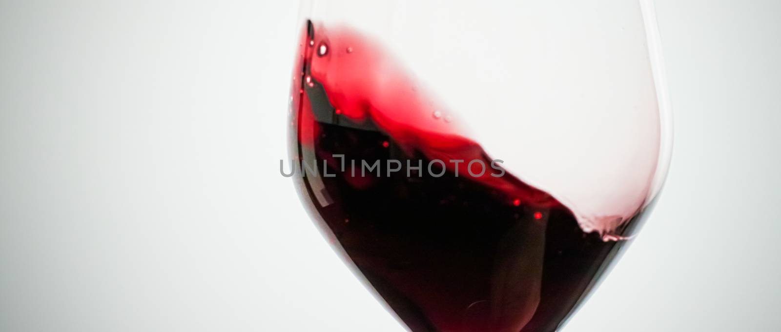 Glass of red wine, pouring drink at luxury holiday tasting event by Anneleven