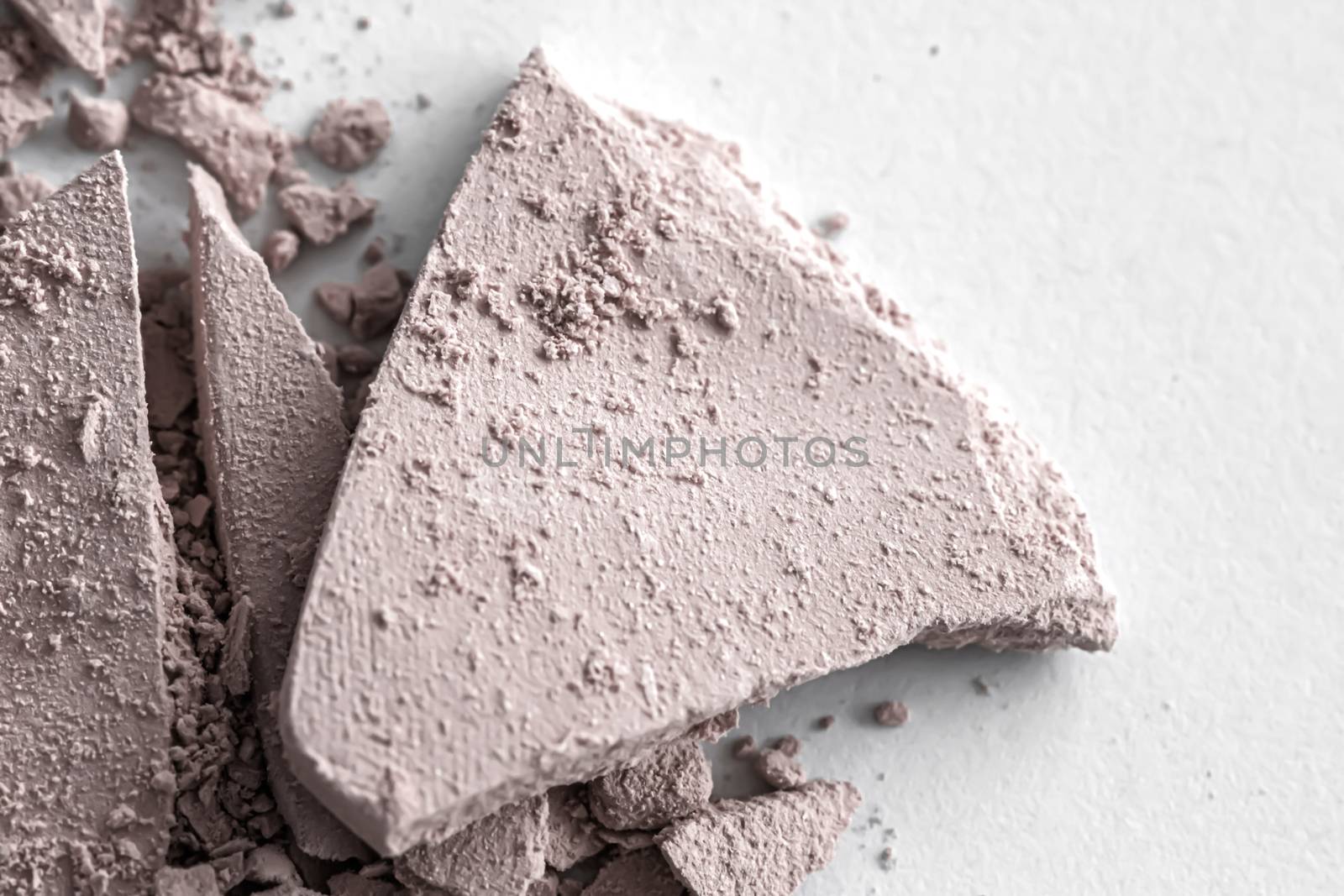 Pale eye shadow powder as makeup palette closeup isolated on white background, crushed cosmetics and beauty textures