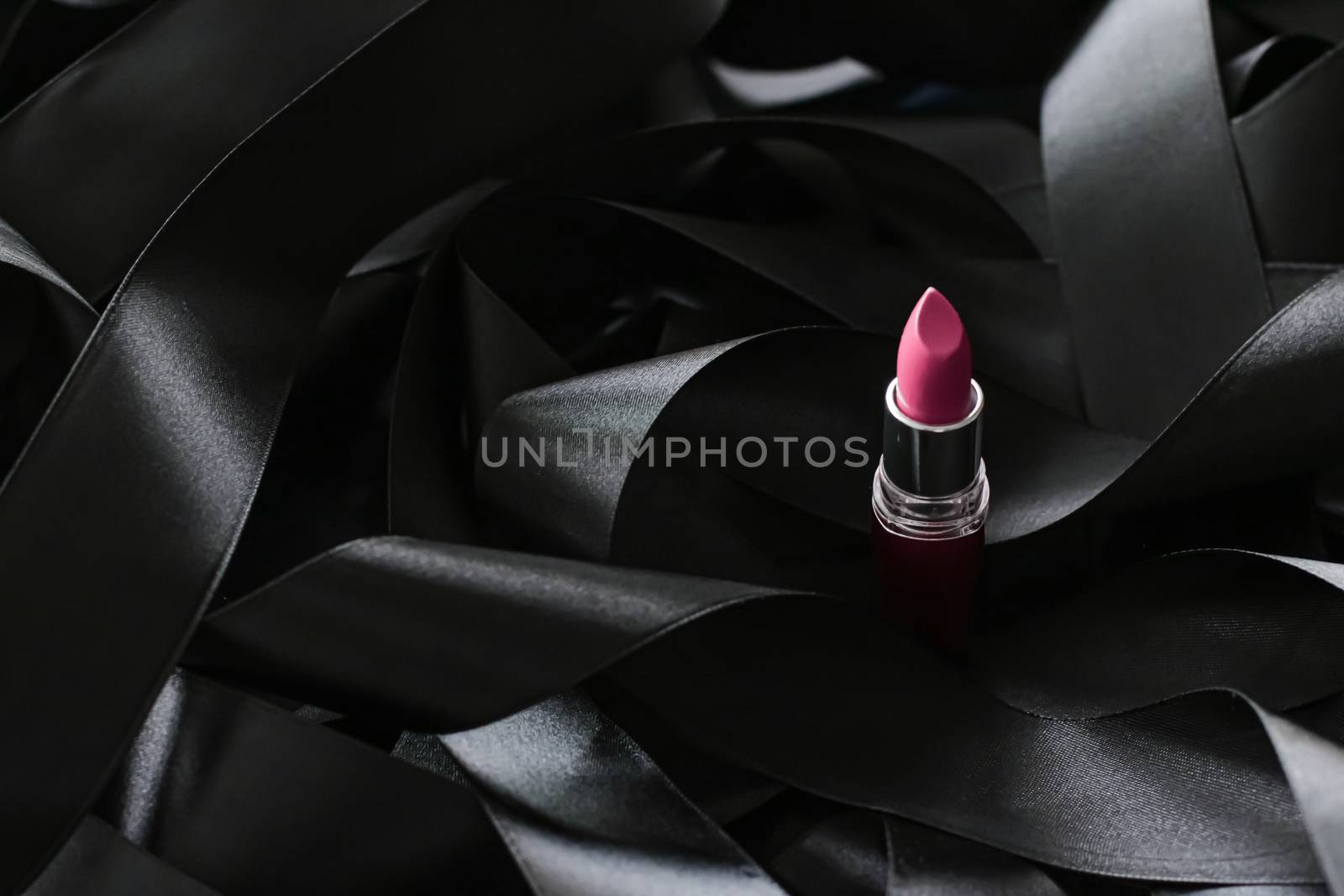 Pink lipstick on black silk background, luxury make-up and beaut by Anneleven