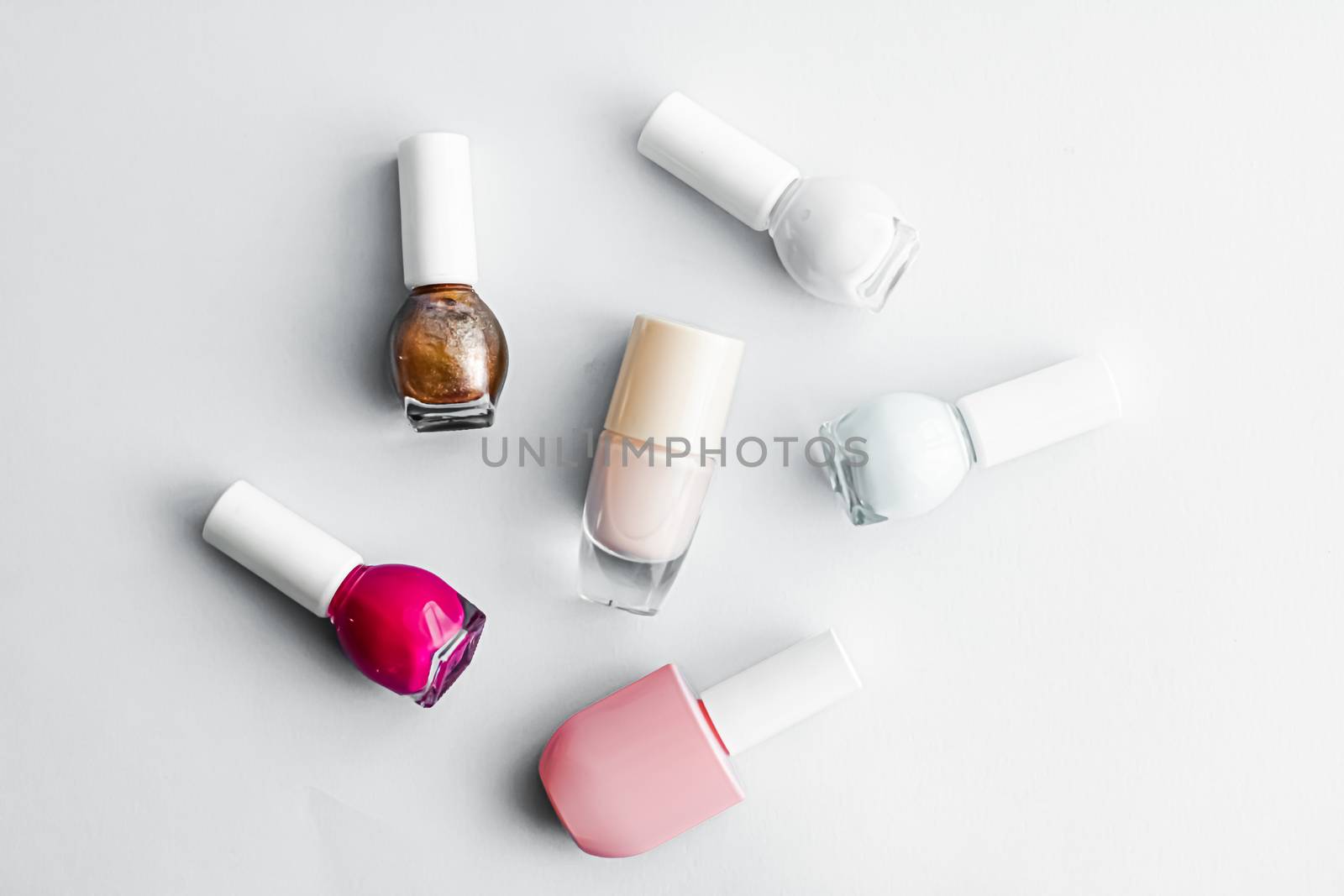 Nail polish bottles on white background, beauty branding