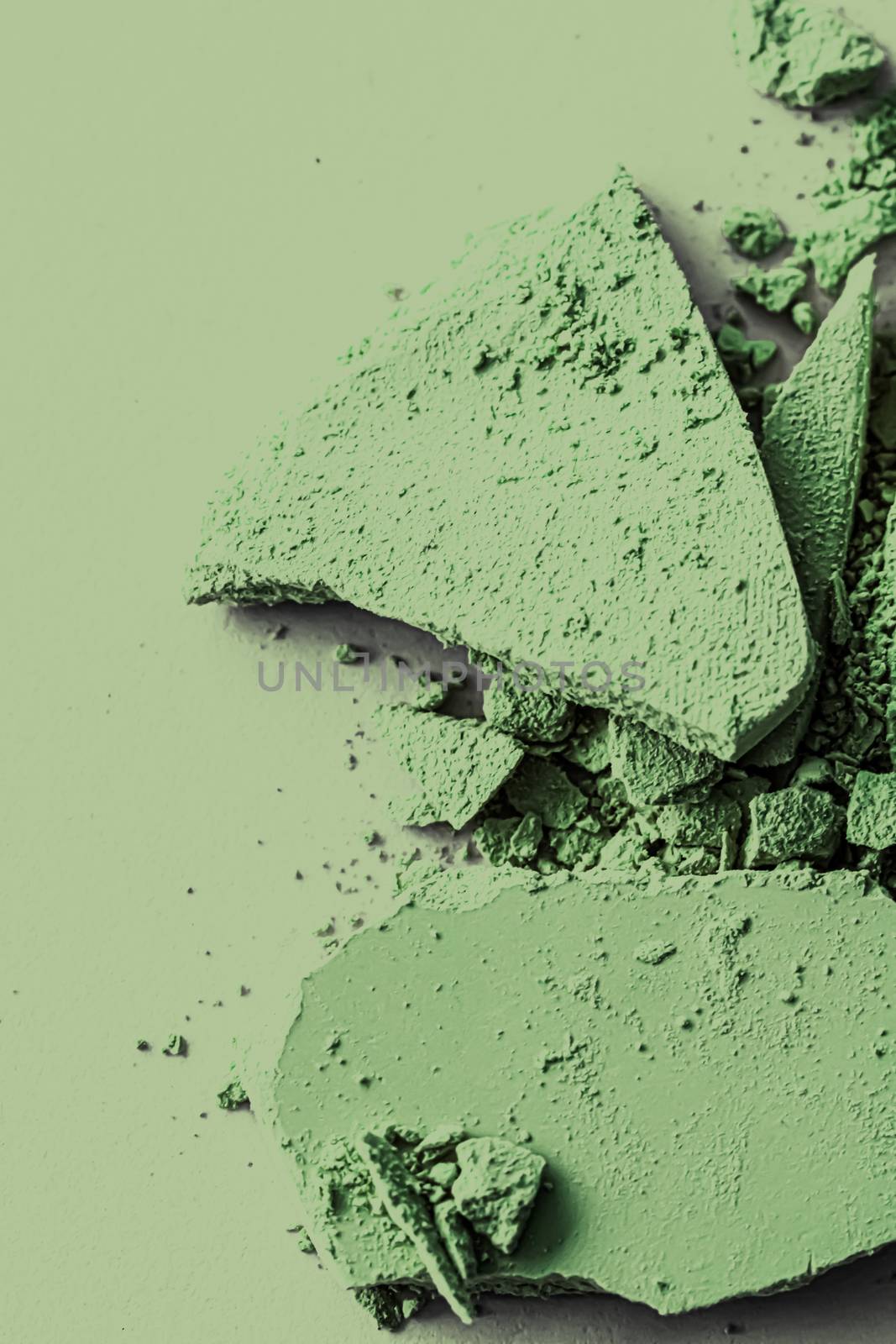 Green eye shadow powder as makeup palette closeup, crushed cosmetics and beauty textures