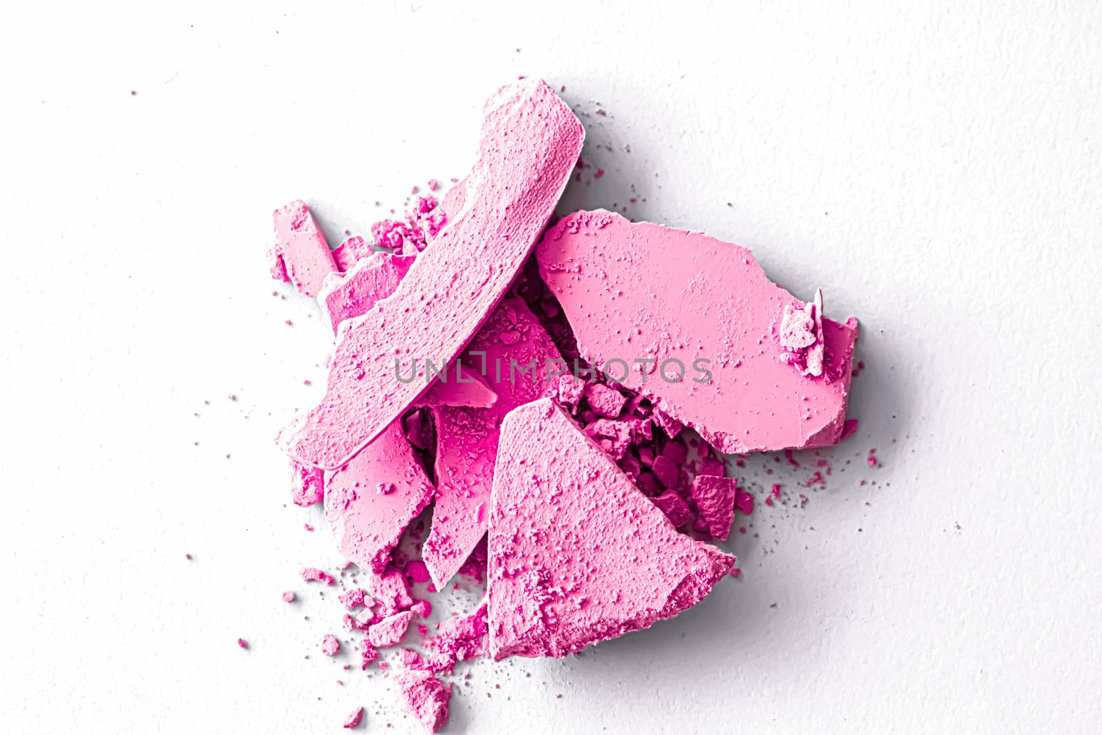 Pink eye shadow powder as makeup palette closeup isolated on white background, crushed cosmetics and beauty textures