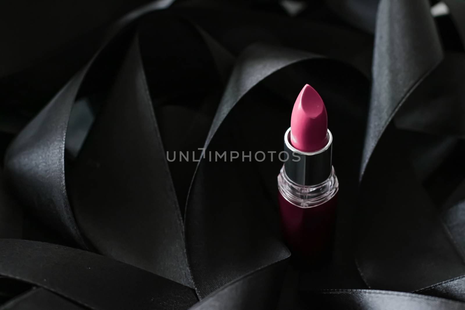 Pink lipstick on black silk background, luxury make-up and beauty cosmetics