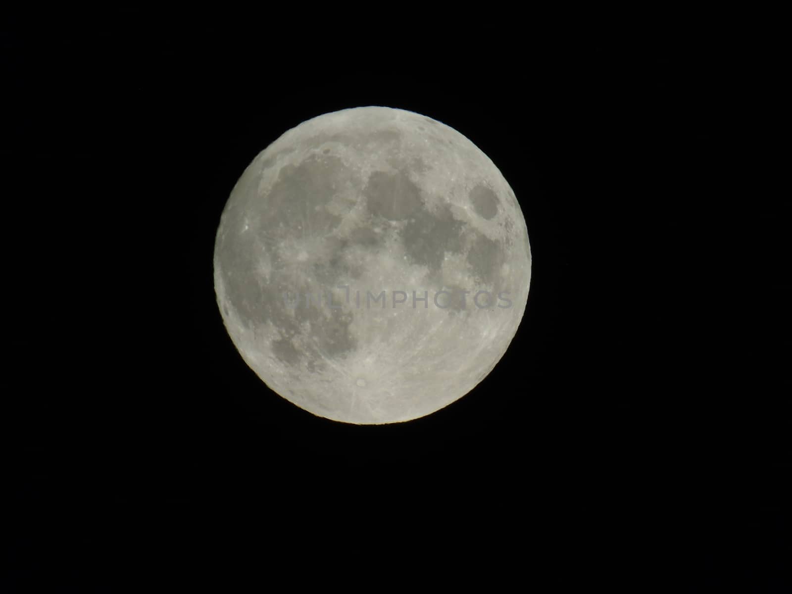 An amazing photography of the full moon over the city of Genova by night with a great clear sky in background and some stars