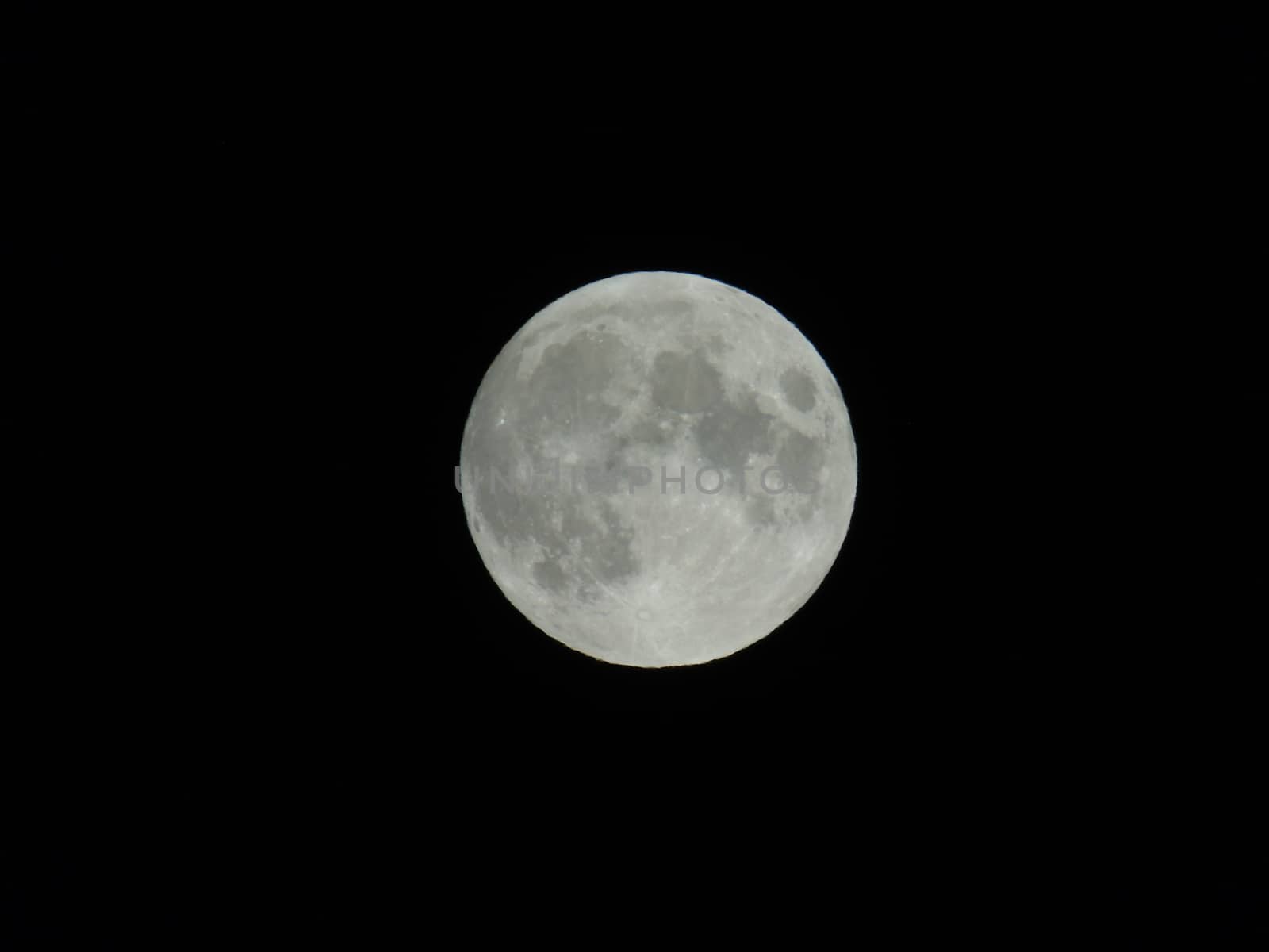 An amazing photography of the full moon over the city of Genova by night with a great clear sky in background and some stars