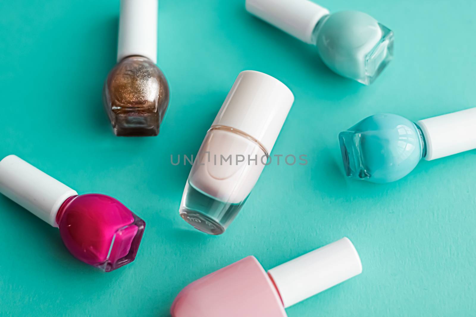 Nail polish bottles on green background, beauty brand by Anneleven