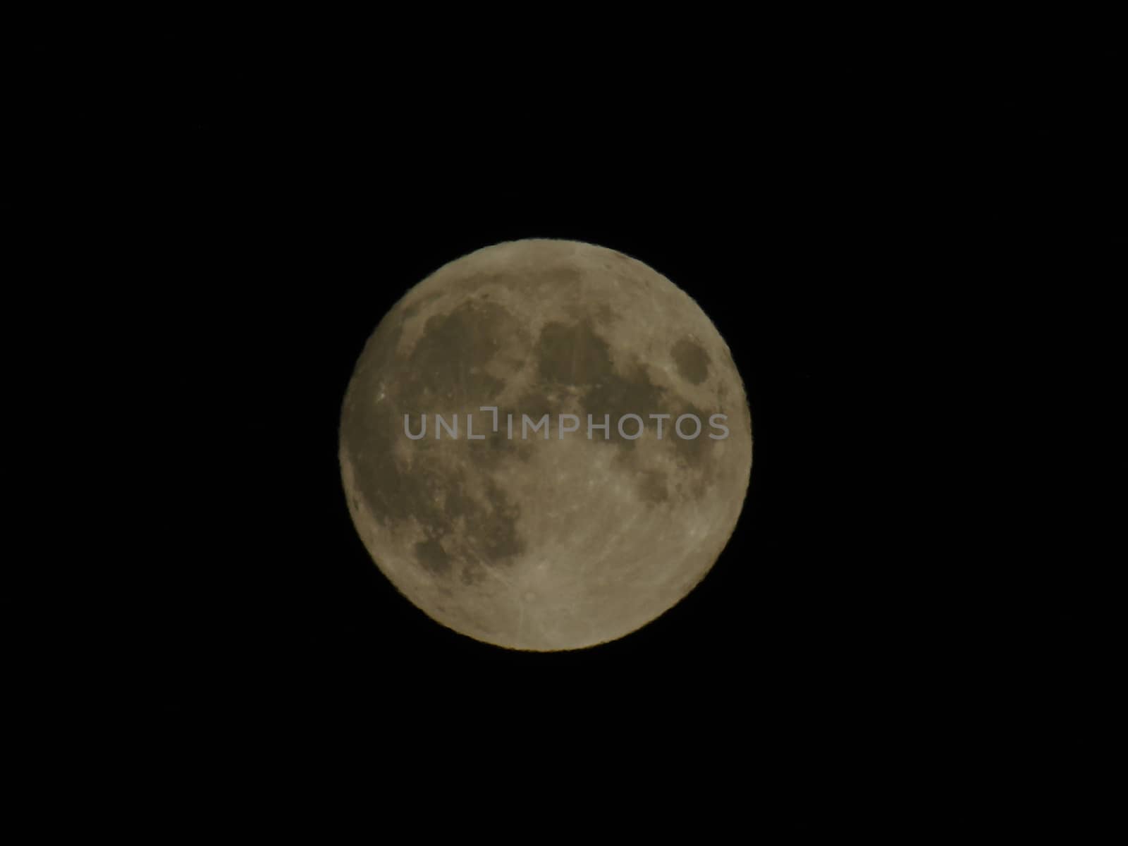 An amazing photography of the full moon over the city of Genova by night with a great clear sky in background and some stars