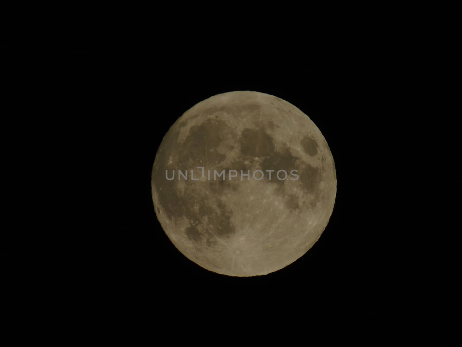 An amazing photography of the full moon over the city of Genova by night with a great clear sky in background and some stars