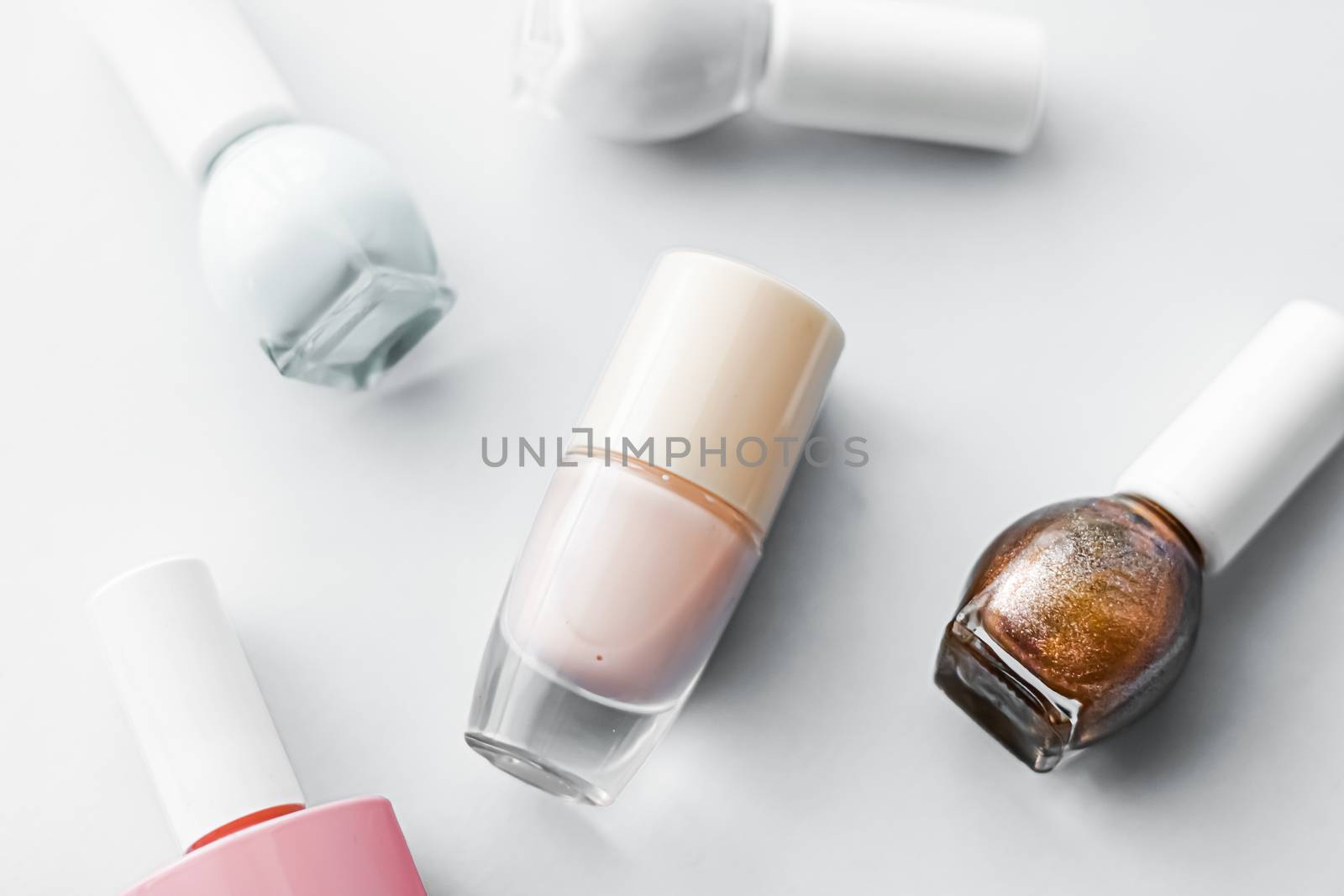 Nail polish bottles on white background, beauty branding