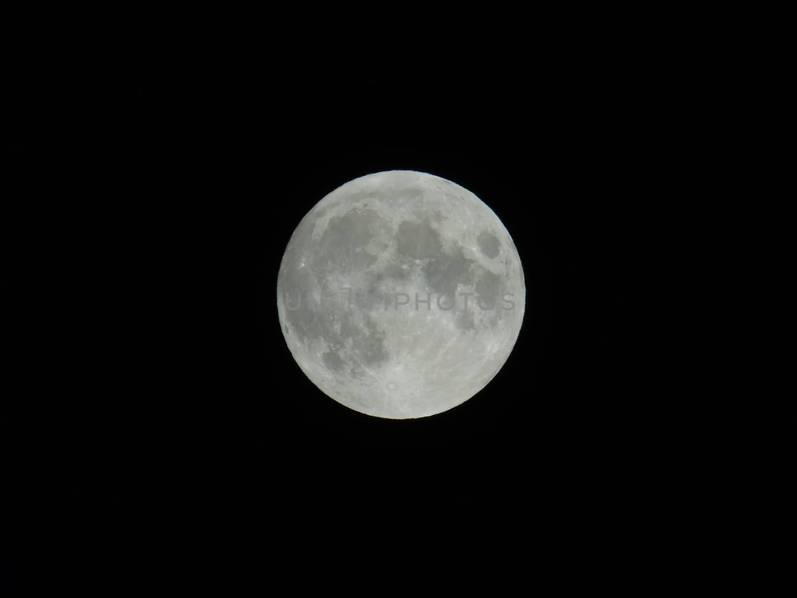 An amazing photography of the full moon over the city of Genova by night with a great clear sky in background and some stars