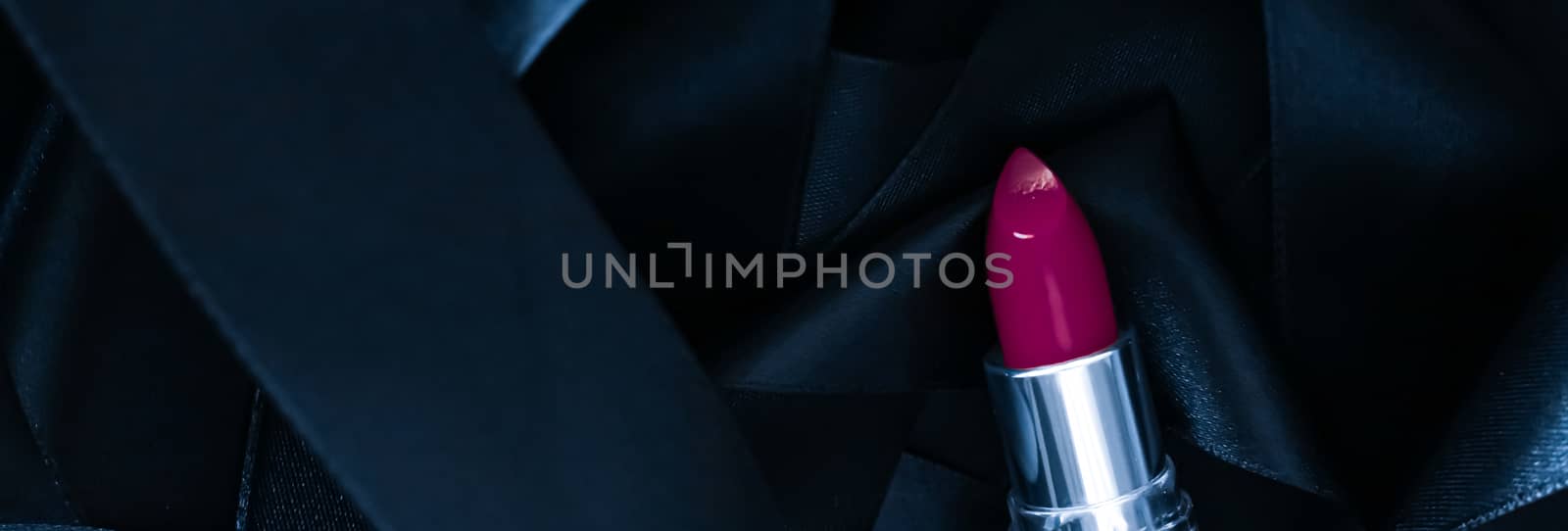 Purple lipstick on black silk background, luxury make-up and beauty cosmetics