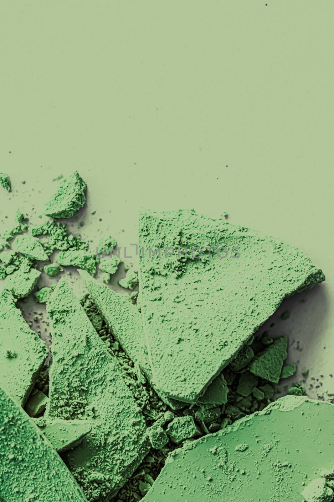 Green eye shadow powder as makeup palette closeup, crushed cosmetics and beauty textures