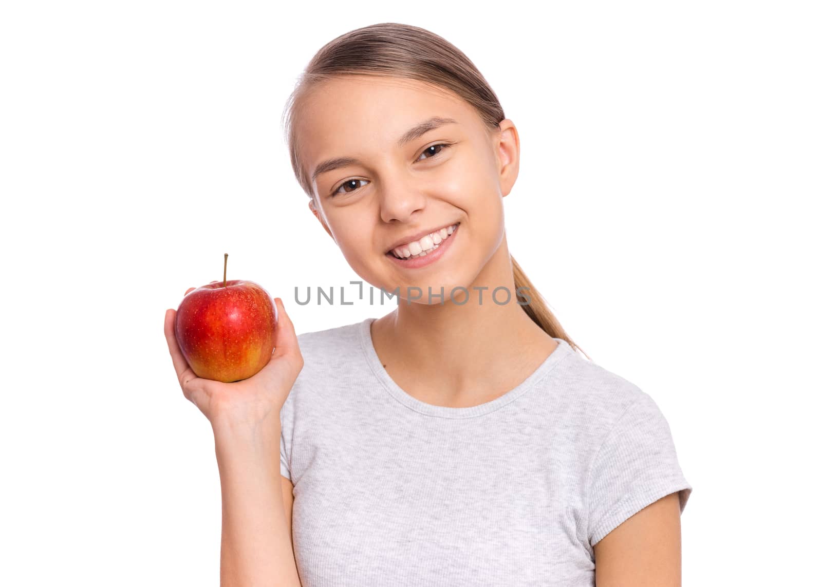 Happy beautiful young teen girl holds apple, isolated on white background