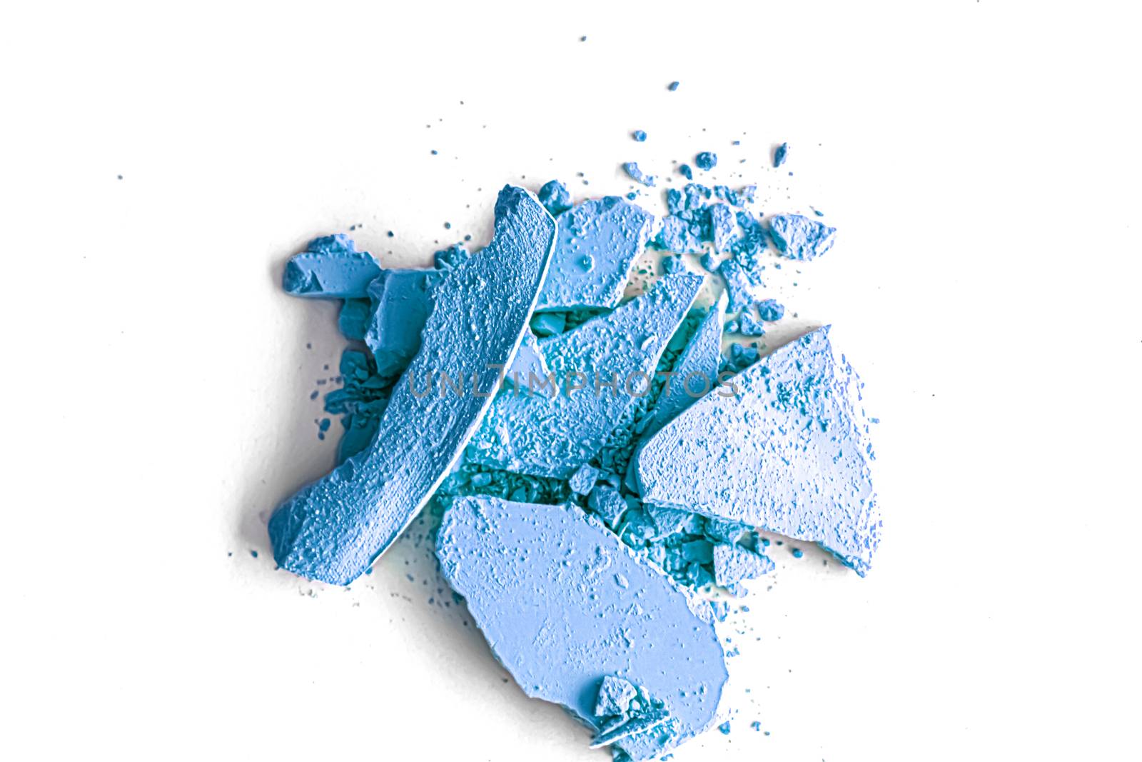 Blue eye shadow powder as makeup palette closeup isolated on white background, crushed cosmetics and beauty textures