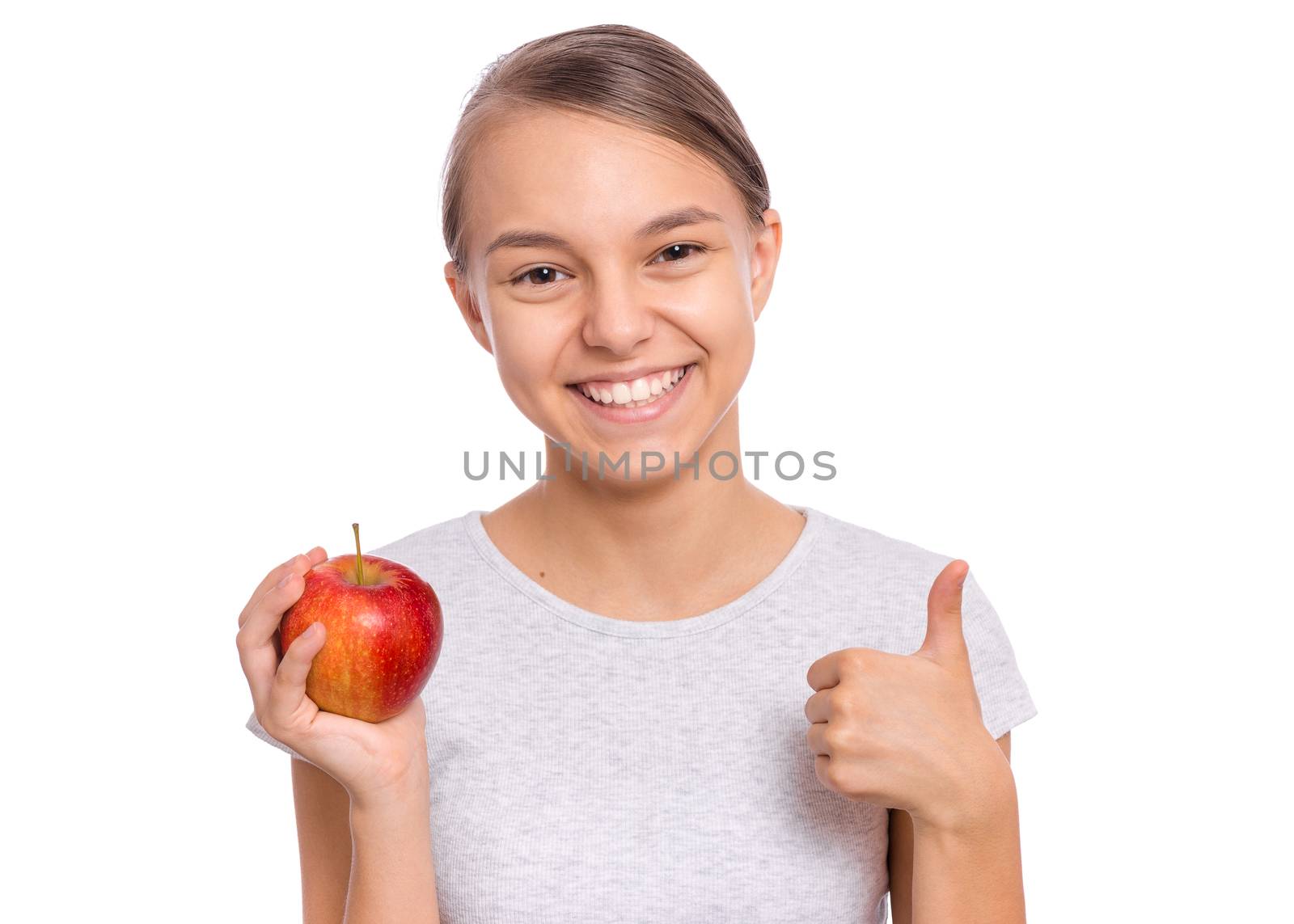 Happy beautiful young teen girl holds apple, isolated on white background
