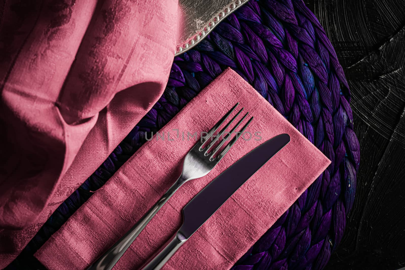 Holiday table setting with pink napkin and silver cutlery, food  by Anneleven