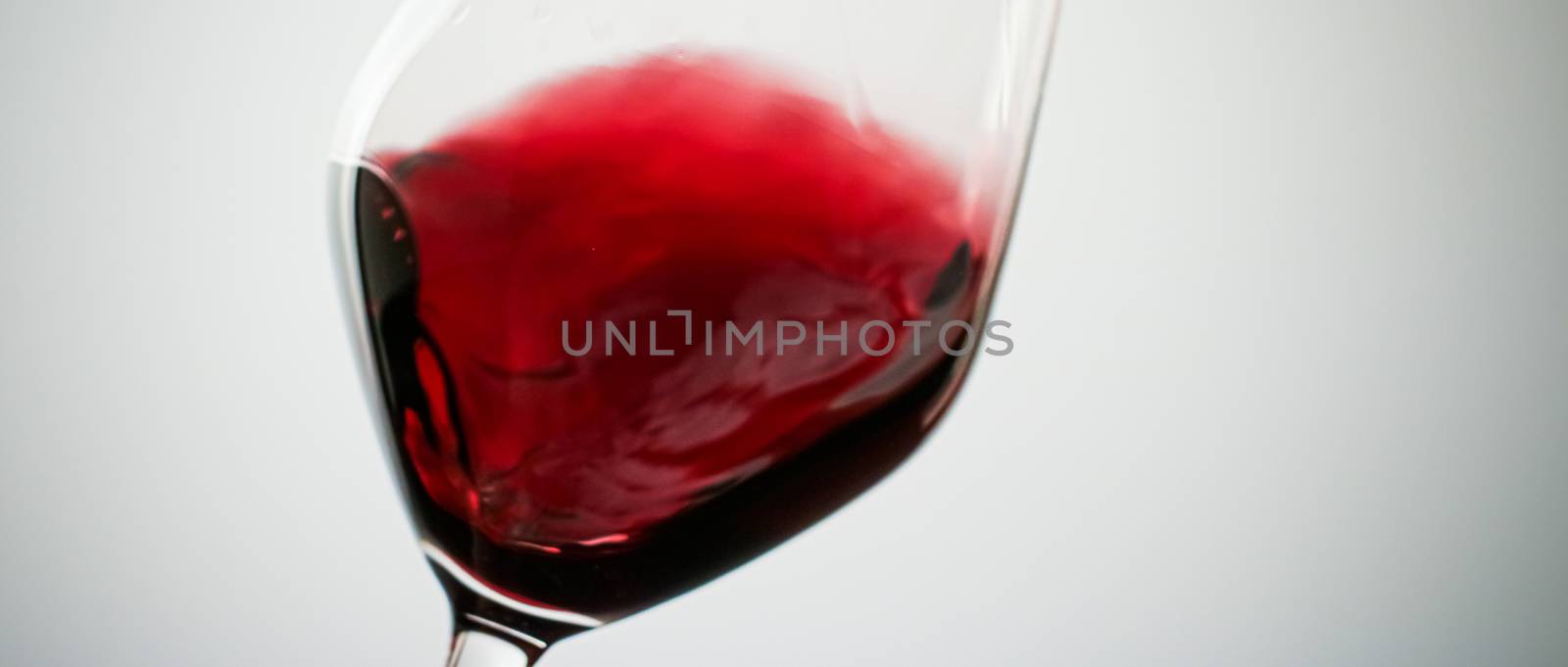 Winery, cheers and winemaking concept - Glass of red wine, pouring drink at luxury holiday tasting event, quality control splashing liquid motion background for oenology or premium viticulture brand
