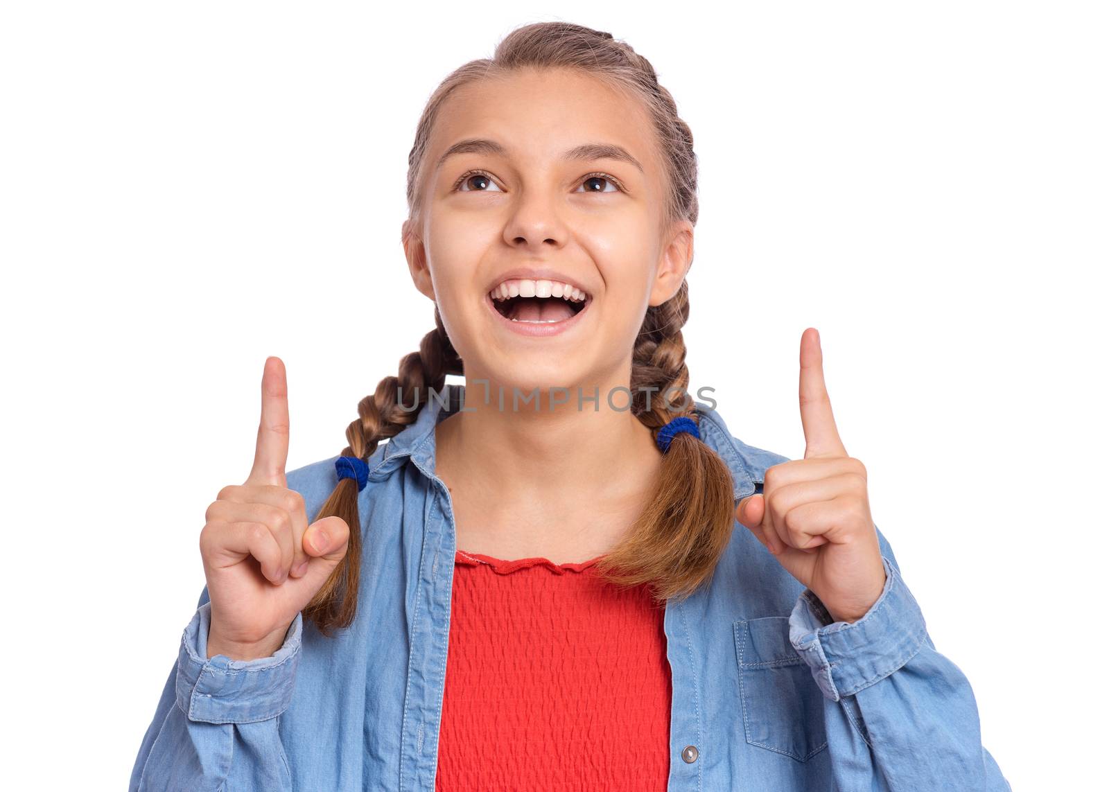 Happy teenage girl pointing up, gesturing idea or doing number one gesture, isolated on white background
