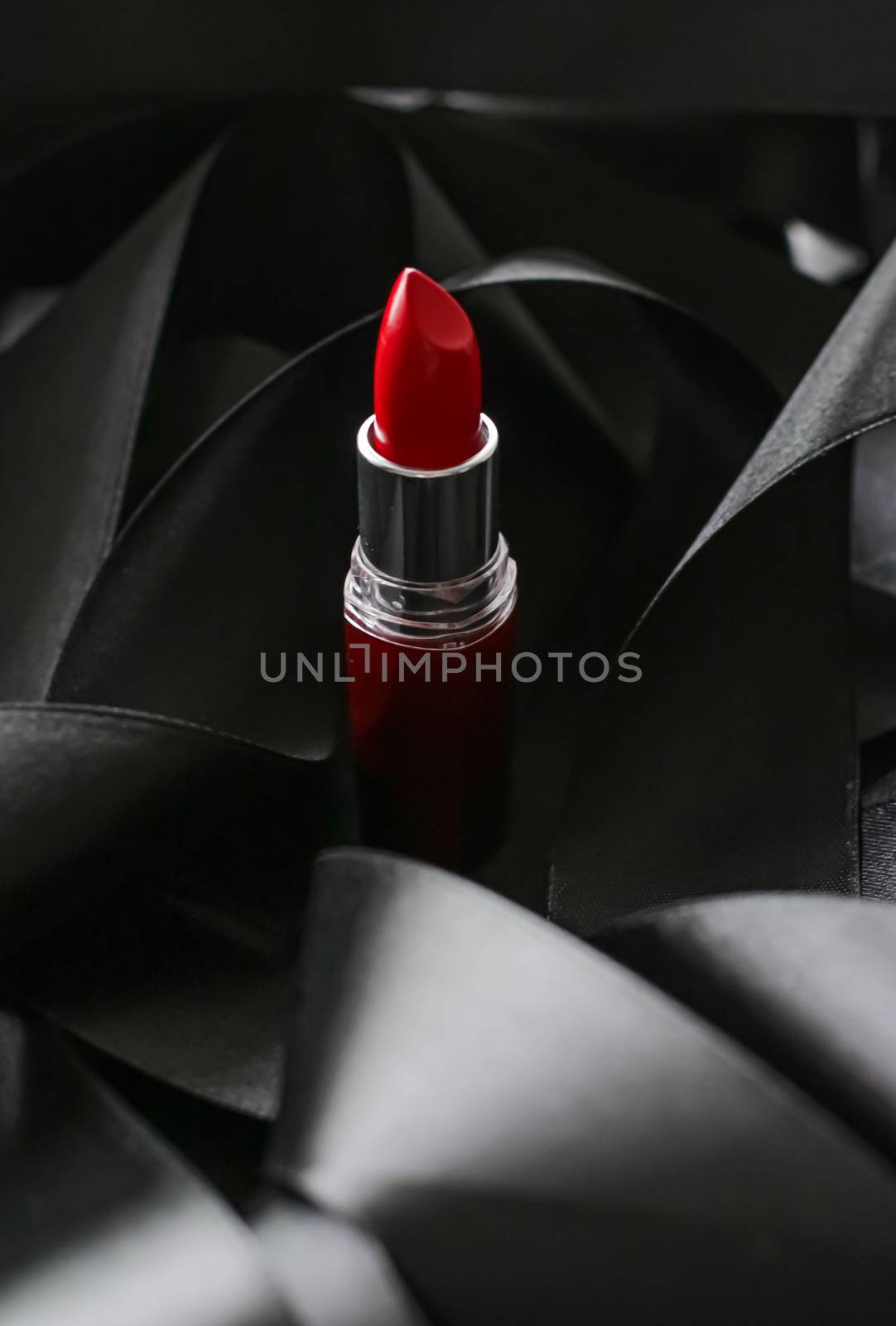 Red lipstick on black silk background, luxury make-up and beauty cosmetics