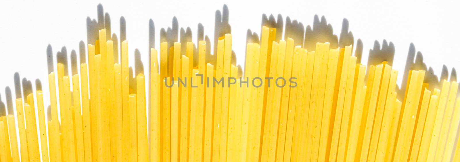 Uncooked whole grain spaghetti closeup, italian pasta as organic by Anneleven