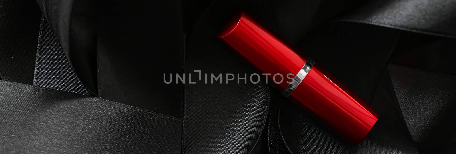 Red lipstick on black silk background, luxury make-up and beauty by Anneleven