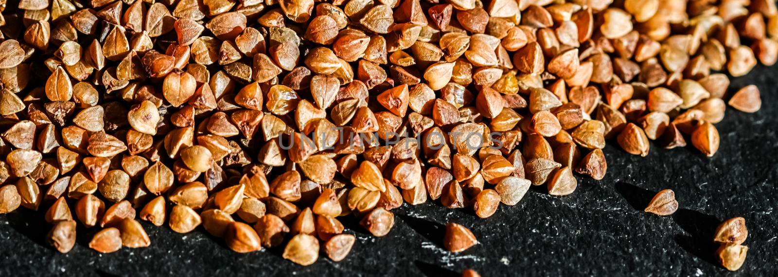 Buckwheat grain closeup, food texture and cook book background by Anneleven