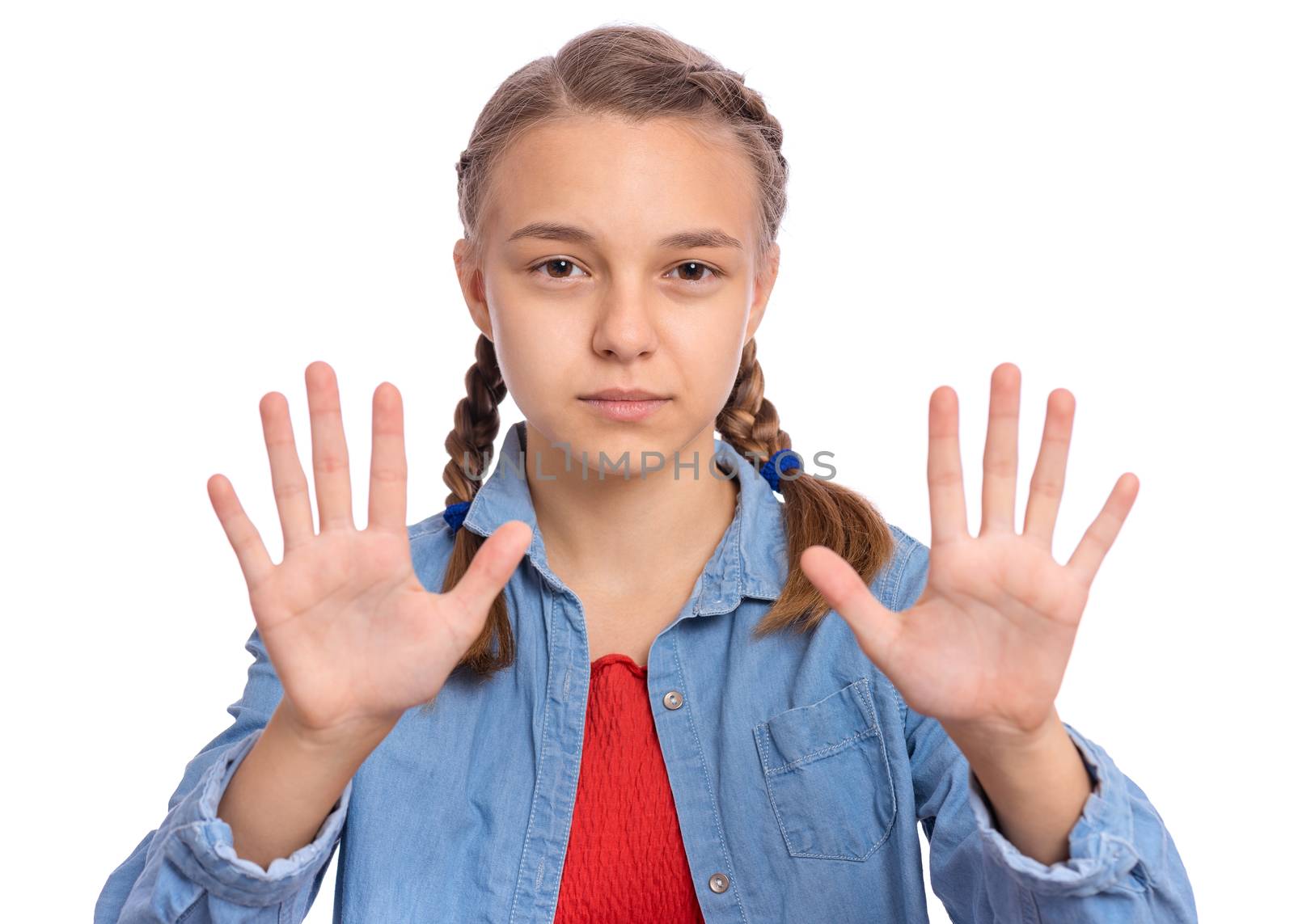 Beautiful teenage girl shows with hands a stop sign on an isolated background