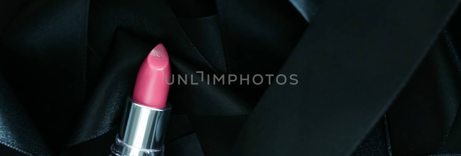 Pink lipstick on black silk background, luxury make-up and beauty cosmetics