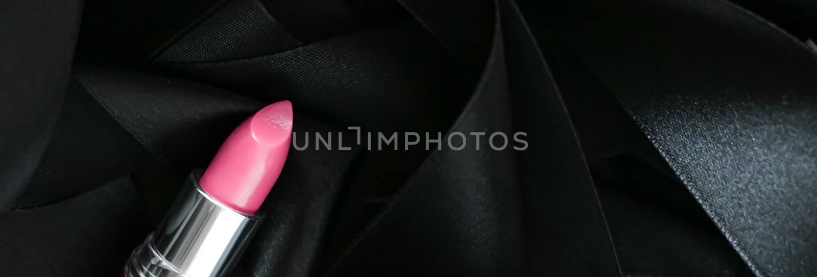 Pink lipstick on black silk background, luxury make-up and beaut by Anneleven